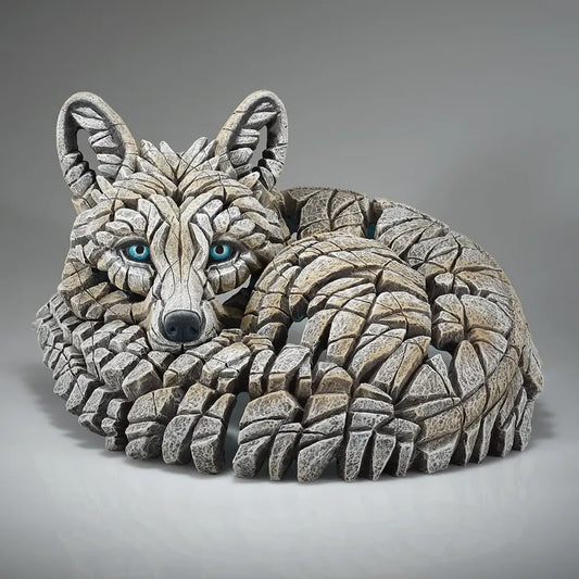 Edge Sculpture of a curled up white artic fox