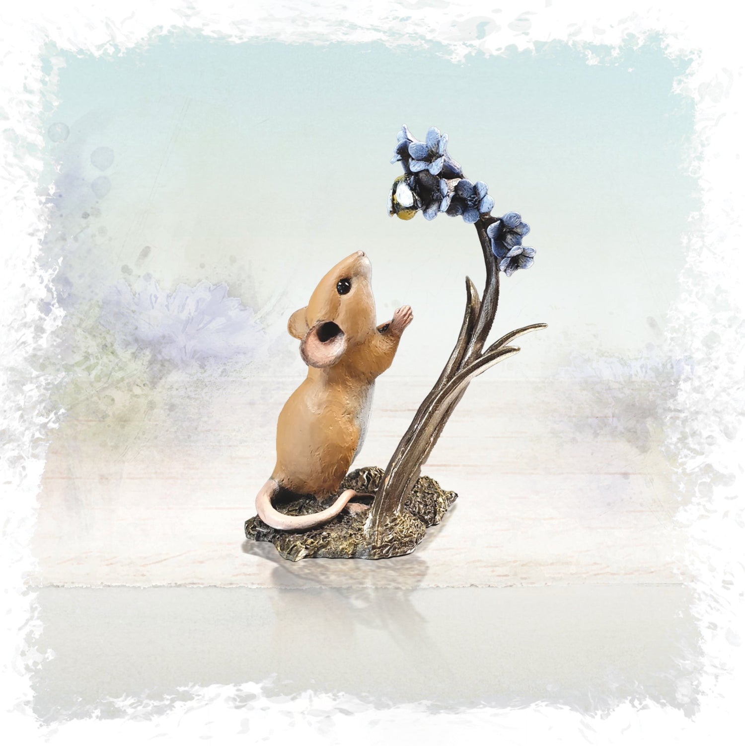 Cold cast bronze sculpture of mouse with bluebells